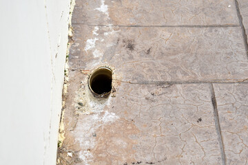 Drain hole on the footpath or pavement. 