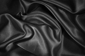 Black shiny fabric background. Dark abstract background.