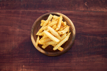 french fries with parmesan cheese on wooden board