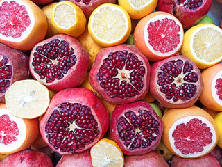 Ripe fresh fruits background. Pomegranates, oranges, lemon and grapefruit are juicy for juice....