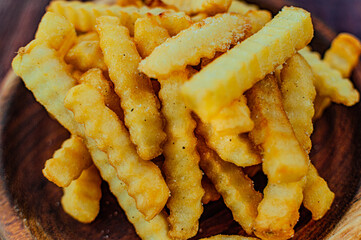 french fries with parmesan cheese on wooden board