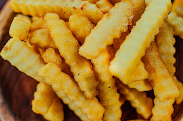 french fries with parmesan cheese on wooden board