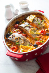 Fish steaks, olives and cherry tomatoes stewed  in tomato sauce
