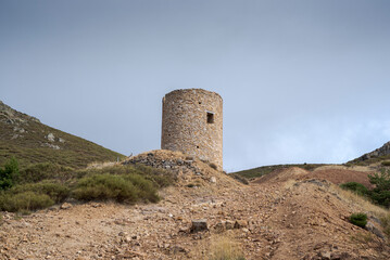 Old wind mill for mineral grinding. Its construction began in the year 1.659. Photo taken in the abandoned silver mine located in the municipality of Bustarviejo, province of Madrid, Spain