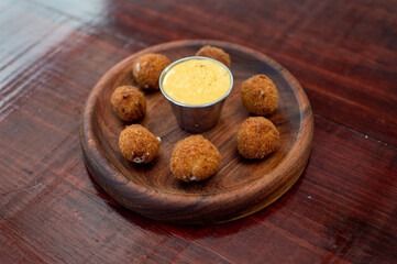 Crispy fast food dipping in cheese sauce