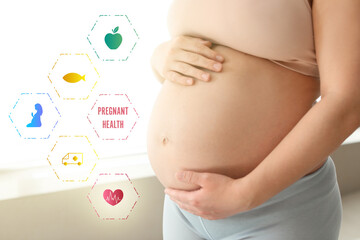 Young pregnant woman with health icons indoors