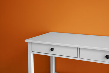 Modern table with drawers near color wall