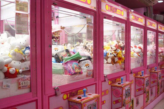 Arcade crane vending machine at Ximending mall game centre. The dolls sold in coin operating machine by using clamp to pull the toy up. Taipei, Taiwan - June 25, 2018