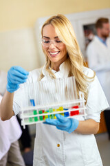 Attractive young woman scientist working in laboratory