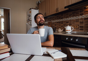Portrait of happy man having a cup of coffee in kitchen