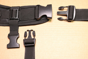 Black plastic buckle fastex for backpacks. Accessories for backpacks, fastener close-up.