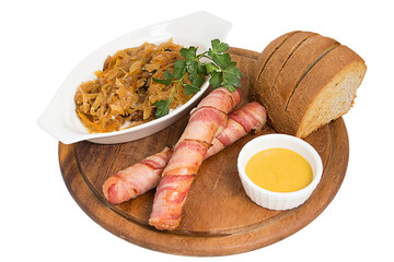 Restaurant serving concept. German, Polish, Austrian cuisine dish, Bigos - cabbage stewed with meat and sausages on a white plate. Close-up.