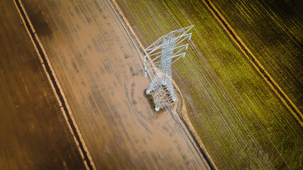 National Electricity grid from top view with Abstract. Aerial view of power line pylon in open paddy field.