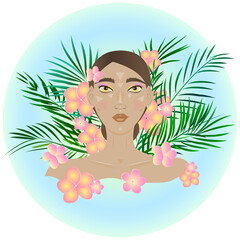 Beautiful girl on a background of tropical leaves and flowers