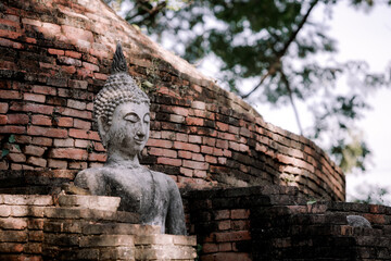 Buddha sculpture statue in the old temple historic park of Thailand.