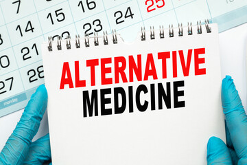 The doctor points to the text ALTERNATIVE MEDICINE , medical concept