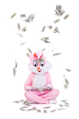 Hundred dollar bills money falls from sky. Easter bunny or rabbit under rain of dollars. Businessman is reading book how to get rich