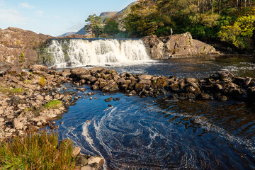 Aasleagh waterfall in county Mayo, Ireland. Warm sunny day, blue sky and water. Popular tourist...