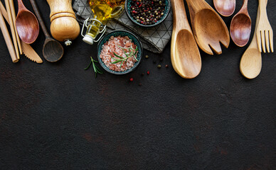 Fototapeta na wymiar Old wooden kitchen utensils and spices as a border
