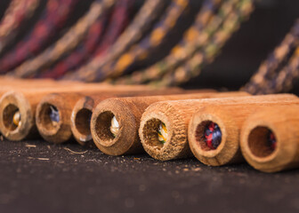 close up of a row of wooden handles for jumping rope