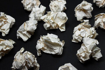 Crumpled paper on a black background. A pile of crumpled paper. Creative crisis. Lack of ideas