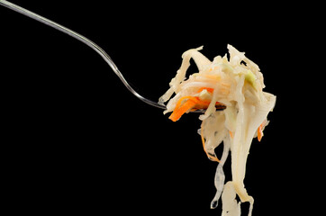 sauerkraut on a fork on a dark