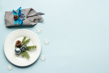 Festive place setting for Christmas dinner with decoration, top view