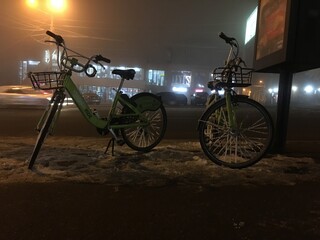 Armenia, Yerevan Komitas street. 5.01.2021. cold winter evening rental bicycles from bank INECOBANK freeze on the street