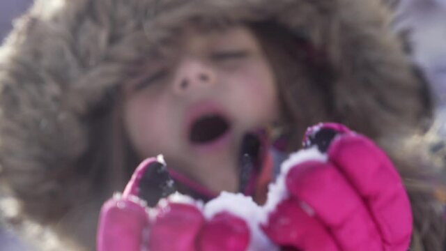 girl playing with snow in the mountains fim in slow motion
