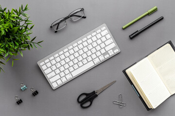 Workplace flat lay with computer and office supplies top view