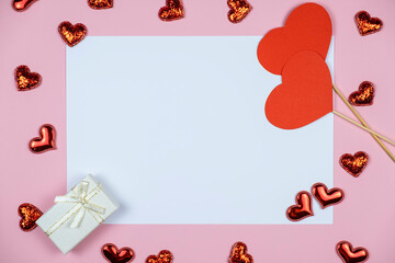 Greeting card with red hearts and gifts. Frame for text. Top view