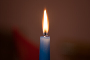 close-up of a burning candle in the dark
