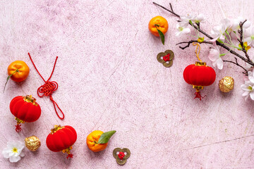 Flat lay of Chinese New Year decoration flowers and red lanterns