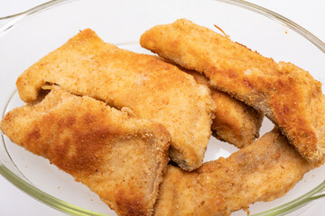 Breaded fish fillets in a glass, heat-resistant dish