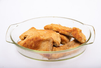 Breaded fish fillets in a glass, heat-resistant dish