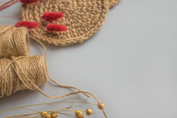 Fototapeta premium Creative composition with natural jute twine roll - linen or cannabis on light gray background with copyspace for text. Handmade and ecological packaging concept, sustainable lifestyle, selective
