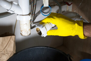 Cleaning the sink siphon in the kitchen