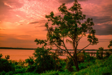 The background of the bridge stretches into the sea, with twilight light in the morning, beautiful colors, sky wallpaper and refreshing surroundings.