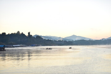 An early morning view with beautiful colorful lights Before sunrise At the Fisherman Village near Mon Market at Mon Bridge, Sangkhlaburi District, Kanchanaburi Province, Thailand