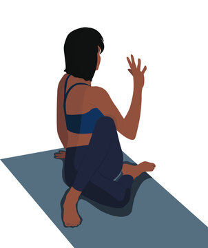 The girl is engaged in yoga sits in a pose on the mat and meditates