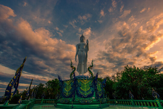 Background of Thailand's Chonburi religious attractions (Wat Khao Phra Khru viewpoint), with beautiful Buddha and Phaya Naga statues, tourists always come to make merit and take pictures at night.