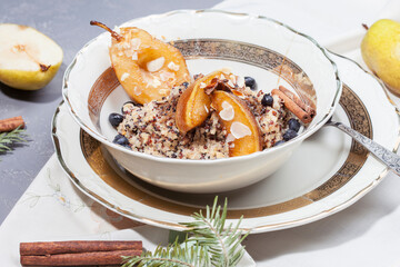 
quinoa porridge with caramelized pear and berries. morning breakfast