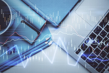 Double exposure of forex graph drawing over desktop background with computer. Concept of financial analysis. Top view.
