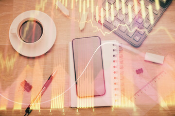 Multi exposure of forex graph hologram over desktop with phone. Top view. Mobile trade platform concept.
