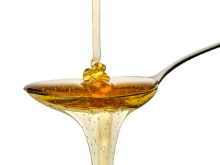 Honey on silver spoon and white background 