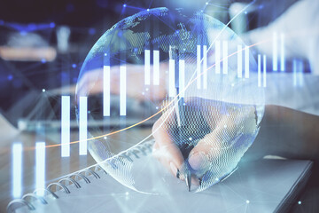 Double exposure of forex chart drawing over people taking notes background. Concept of financial analysis