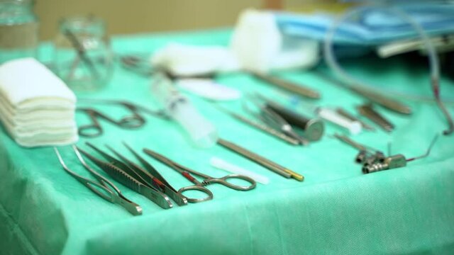 Surgical tools, medical supplies are on sterile surgical tray, table in hospital operating room. Health Care concept of medicine
