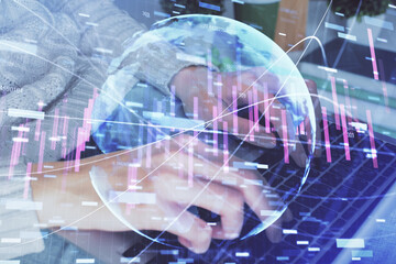 Double exposure of woman hands typing on computer and forex chart hologram drawing. Stock market invest concept.