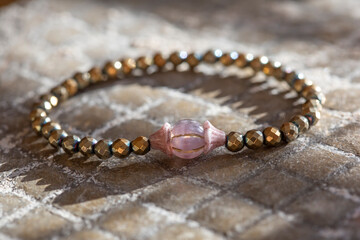 Mineral gemstone bracelet placed on natural grey background