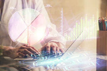 Double exposure of woman hands typing on computer and forex chart hologram drawing. Stock market...